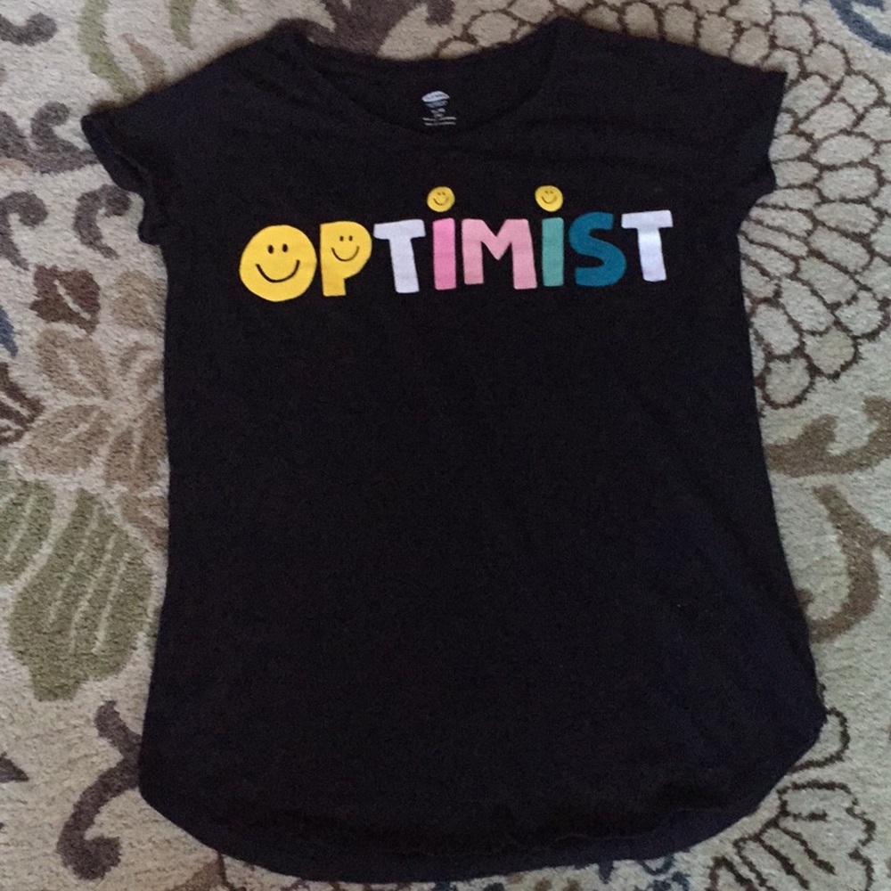 A extra large T-Shirt that says “Optimistic” on it